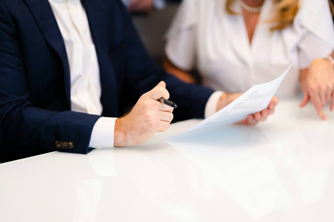 Two people reviewing documents across a table